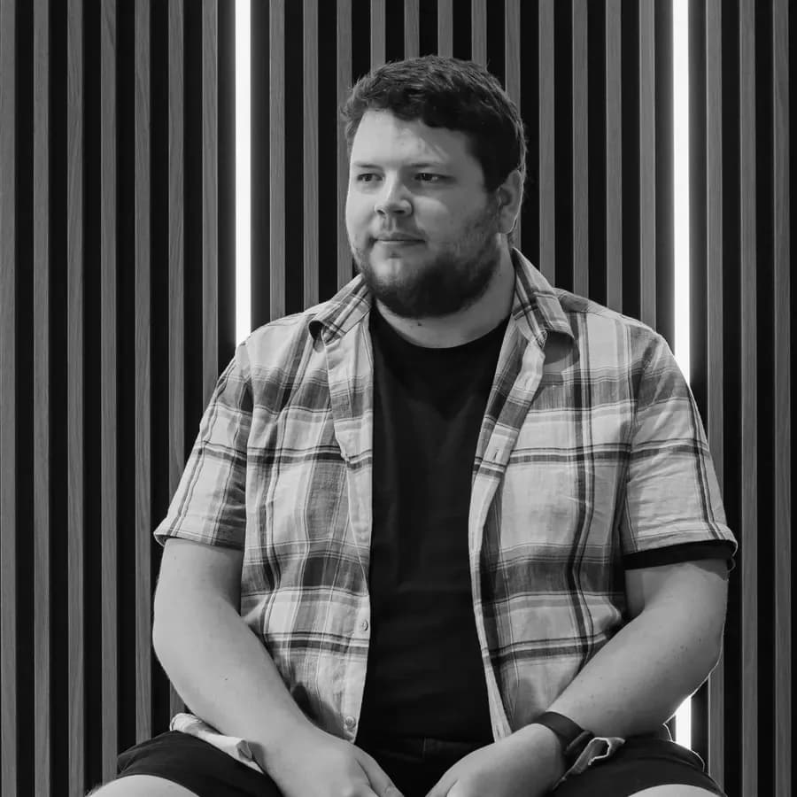 Dayle Frost, who runs Lighthouse, sitting in front of a slatted wooden wall